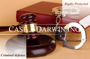 Table with a gavel, handcuffs, and a leather-bound book, with overlay text reading "Rights Protected, Criminal Defense, Case J. Darwin, INC."