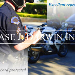 Police officer writing a ticket in front of a motorcycle and a car, with overlay text reading "Excellent Representation, Driving Record Protected, Case J. Darwin, INC."