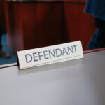 Defendant sign on a courtroom table