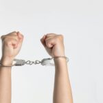 A person's hands in handcuffs